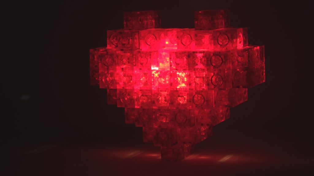 Two flashlights placed in heart shape box luminescence test